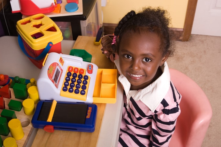 child playing with cash register