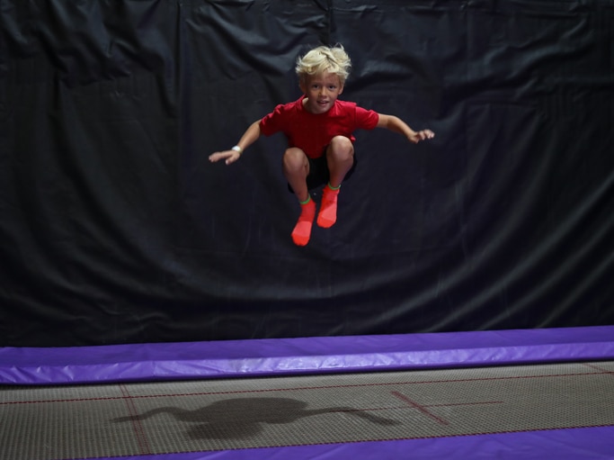 boy jumping on trampoline