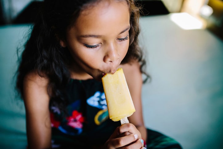 girl eating popsicle