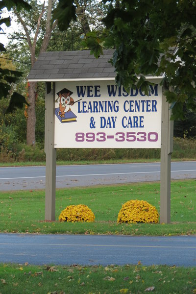 Wee Wisdom Learning Center And Day Care Logo